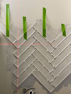 some green tape is taped to the wall