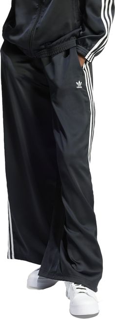 These wide-leg track pants embrace the heritage of adidas while looking ahead to the future. You'll move with ease thanks to the loose, flowing fit that creates an effortlessly casual silhouette. Crafted from luxurious satin, they exude a sense of elegance perfect for a night out or a casual brunch. Signature 3-Stripes run down the sides of the legs, a detail as timeless as the look itself. Fit & Design: Loose fit Drawcord on elastic waist Wide legs Side seam pockets Additional Details: This product is made with at least 70% recycled materials Wide Leg Track Pants, To The Future, Wide Legs, Track Pants, Adidas Originals, The Future, Elastic Waist, Wide Leg, Track