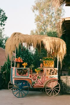 an old fashioned fruit cart with straw roof