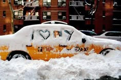 a car covered in snow with the word love written on it