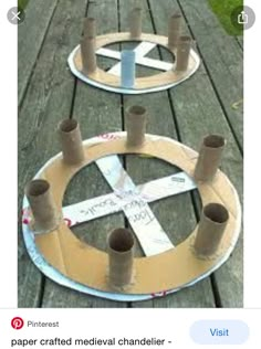 three round wooden boards with holes in them on a picnic table outdoors, one is made out of cardboard and the other has some tape wrapped around it