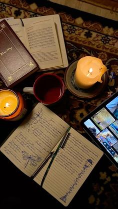 a table topped with notebooks and books next to a cell phone