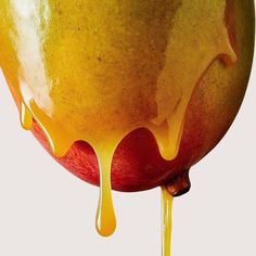 an apple with yellow liquid dripping from it