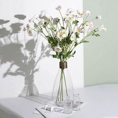 a vase filled with white flowers on top of a table