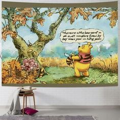 a winnie the pooh tapestry hanging on a wall