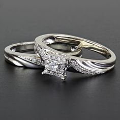 two white gold wedding rings with diamonds on each one and an engagement ring in the middle