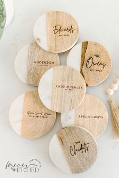 wooden coasters with names and tassels on them