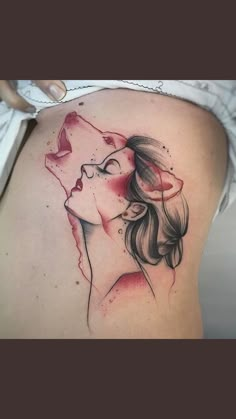 a woman's back with a tattoo on it