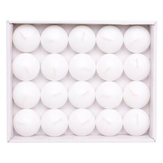 white candles in a box on a white background