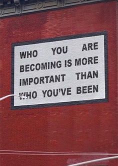 a sign on the side of a building that says, who you are becoming is more important than 40 you've been