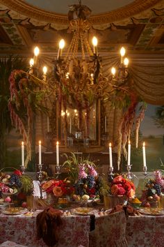 a fancy dining table with flowers and candles