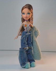 a doll with long hair wearing blue jeans