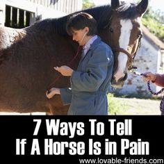 a woman is standing next to a horse and listening to headphones on her ear