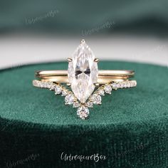 an engagement ring set with a pear shaped diamond in the center and side stones on each band