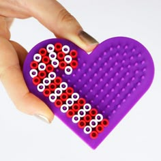 a person holding a purple heart shaped comb