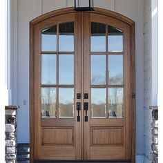 the front door is made of wood and has two sidelights on each side,