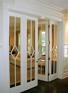 the interior of a bedroom with mirrored doors