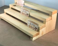 three wooden benches sitting next to each other on top of a carpeted floor in front of a blue wall