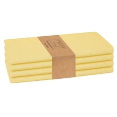 four yellow sponge pads stacked on top of each other