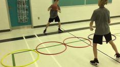 two young men playing with colorful hoop rings