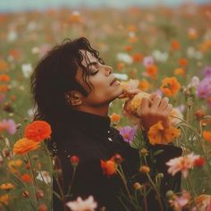 a woman in a field of flowers eating something