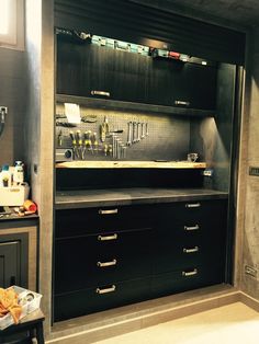 a black cabinet with lots of bottles on it in a room filled with other items