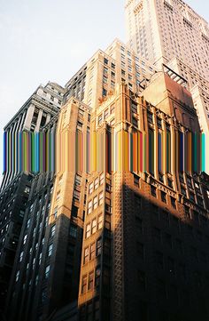 the top of a tall building with multicolored lines on it's side