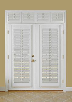 two white doors with shutters on each side in front of a tan wall and tiled floor