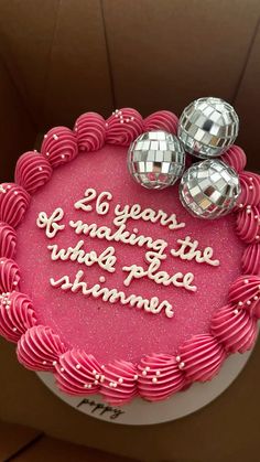 a birthday cake with pink frosting and disco balls on top that says, 60 years of making the world's best summer