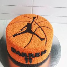 a cake that is decorated to look like a basketball ball