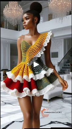 a woman wearing a dress made out of crochet and knitted yarns