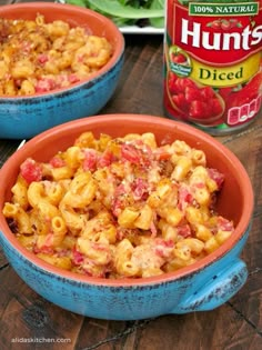 two bowls filled with macaroni and cheese next to a can of hunt's diced