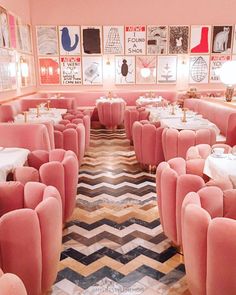 the interior of a fancy restaurant with pink velvet booths