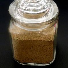 a glass jar filled with sand sitting on top of a table