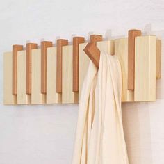 a white towel hanging on a wooden coat rack