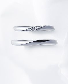 two white gold rings with diamonds on them