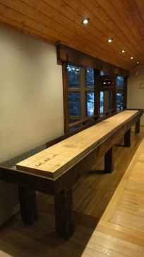 a long wooden bench sitting in the middle of a room