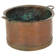 an old, rusty metal pot with handles