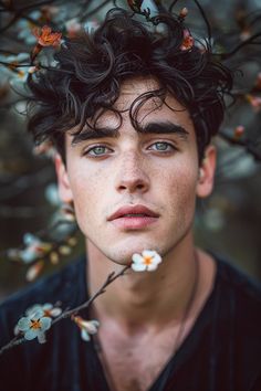 a young man with flowers in his hair