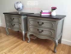 two gray dressers with black top and drawers on wooden floor next to white wall