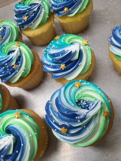 cupcakes decorated with blue, green and white frosting