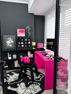 a black and pink room with zebra rugs on the floor in front of it