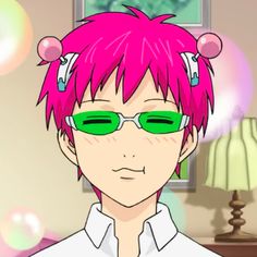 a man with pink hair and green glasses in a living room next to a lamp