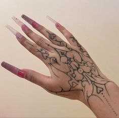 a woman's hand with some tattoos on it