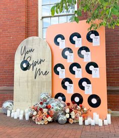 there are many records on the ground next to each other and candles in front of them