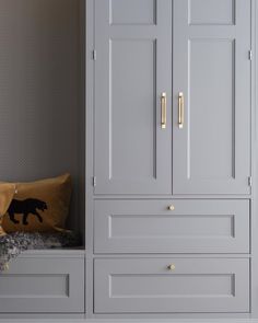 a room with gray cupboards and yellow pillows