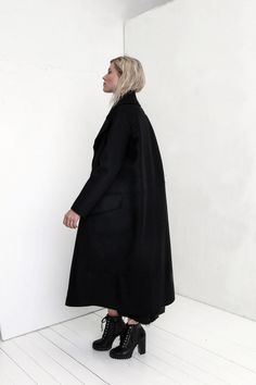 "Premium quality Black woolen coat has an oversize silhouette through the body , crafted in a heavy and thick high quality Italian wool fabric. Calf-length coat is fastened with two knobs. The coat has a unique cut , features big collar, long sleeves and is very stylish. This coat has a horizontal line through the front and back, there are large pockets in front. On one side on the shoulder is a decorative detail. The coat is with viscose lined. This coat is very stylish and unique created by a Black Oversized Long Sleeve Pea Coat, Oversized Long Wool Coat For Winter, Oversized Long Wool Coat For Work, Black Oversized Long Wool Coat, Oversized Wool Pea Coat, Black Long Wool Coat For Winter, Oversized Black Wool Pea Coat, Oversized Black Wool Coat For Winter, Oversized Black Wool Coat For Fall