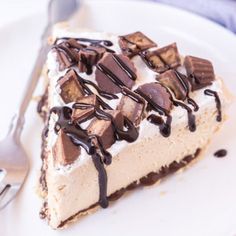 a piece of cheesecake with chocolate and whipped cream on top is sitting on a white plate