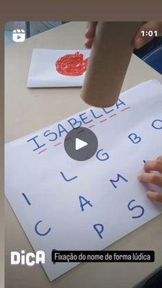 a person is writing on a piece of paper with spanish letters and numbers in it