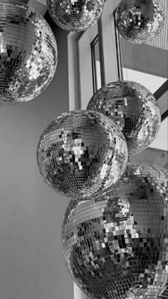 several shiny disco balls hanging from the ceiling